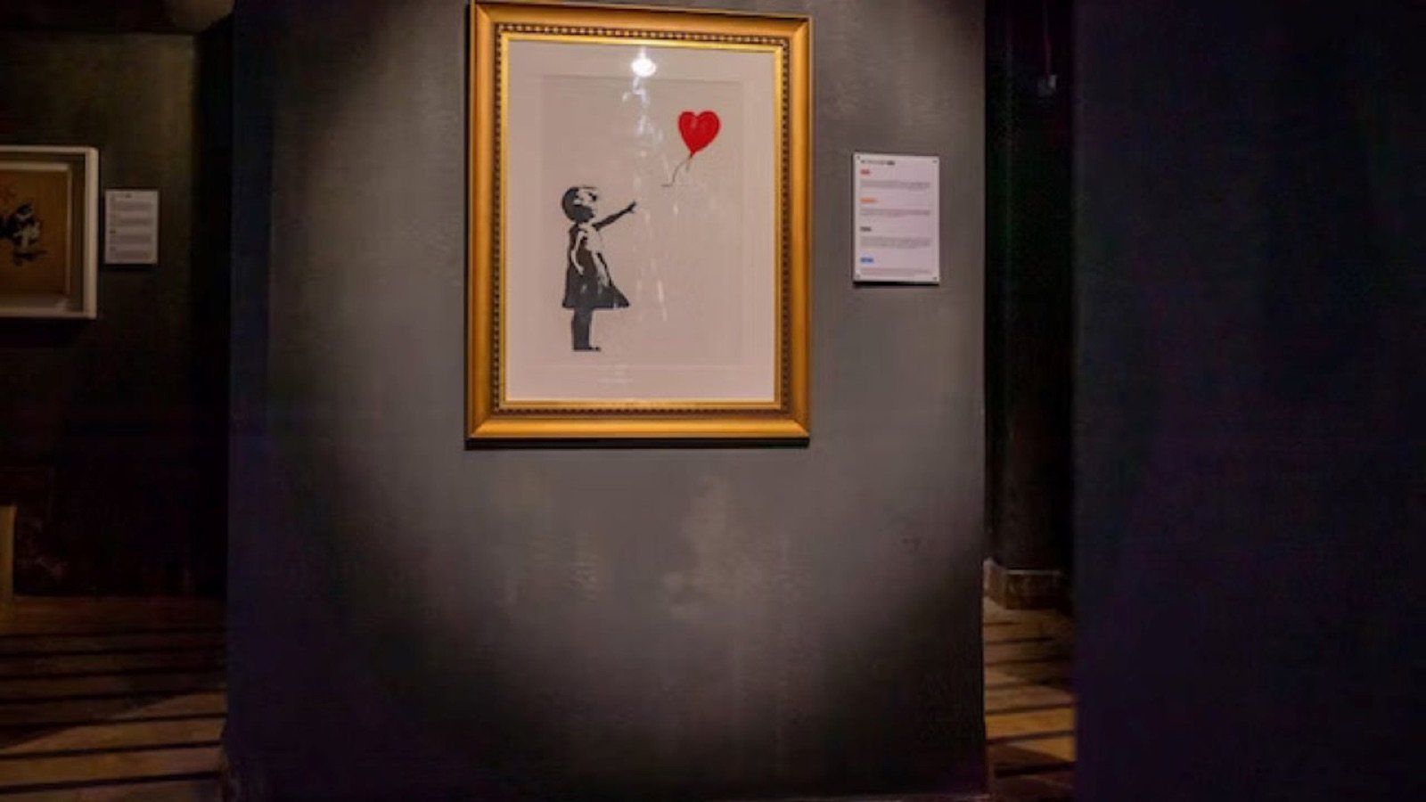 Visitor exploring Banksy's political artworks