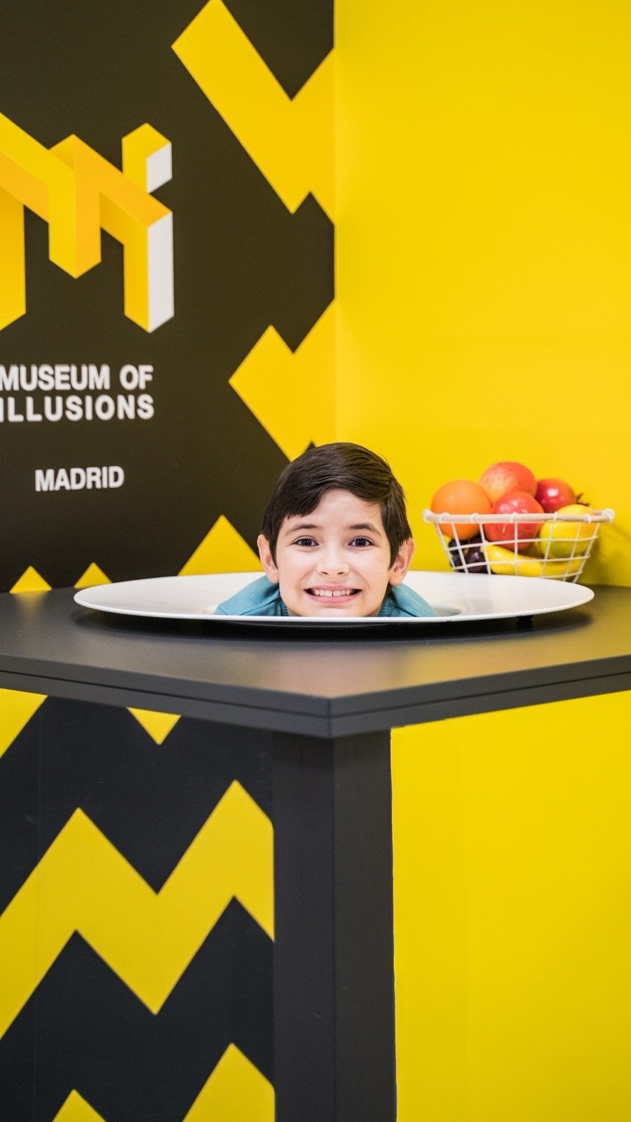 Family exploring illusions together at the museum