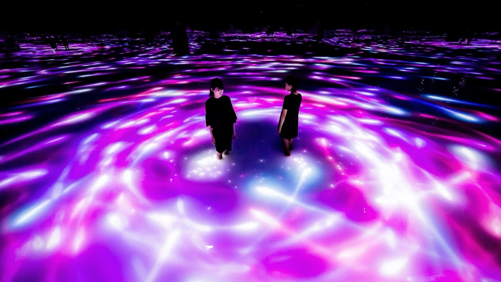 Visitors interacting with immersive artworks