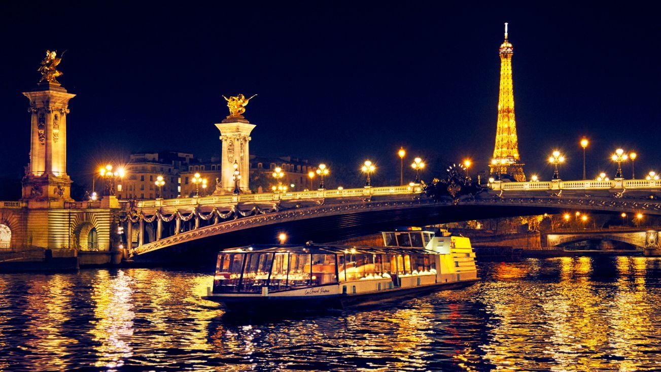 Dinner cruise boat sailing on the Seine River in Paris