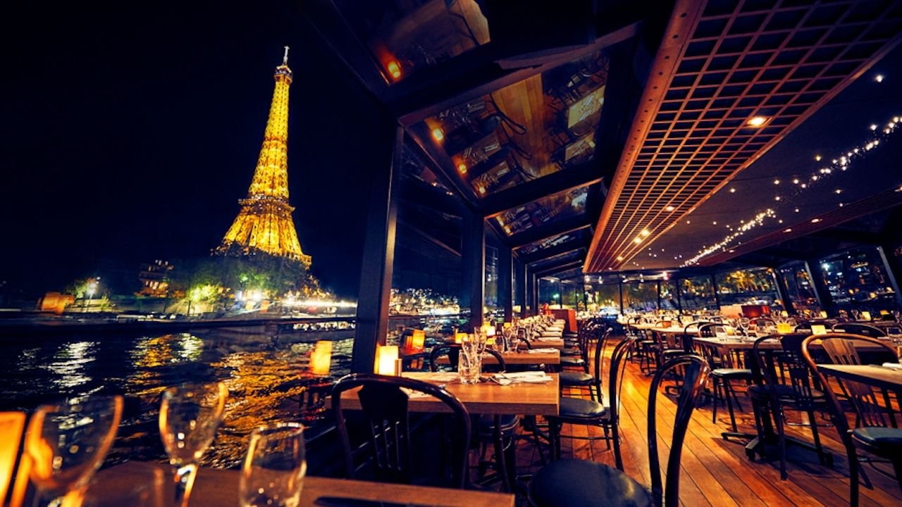 Illuminated Eiffel Tower viewed from the Seine River at night