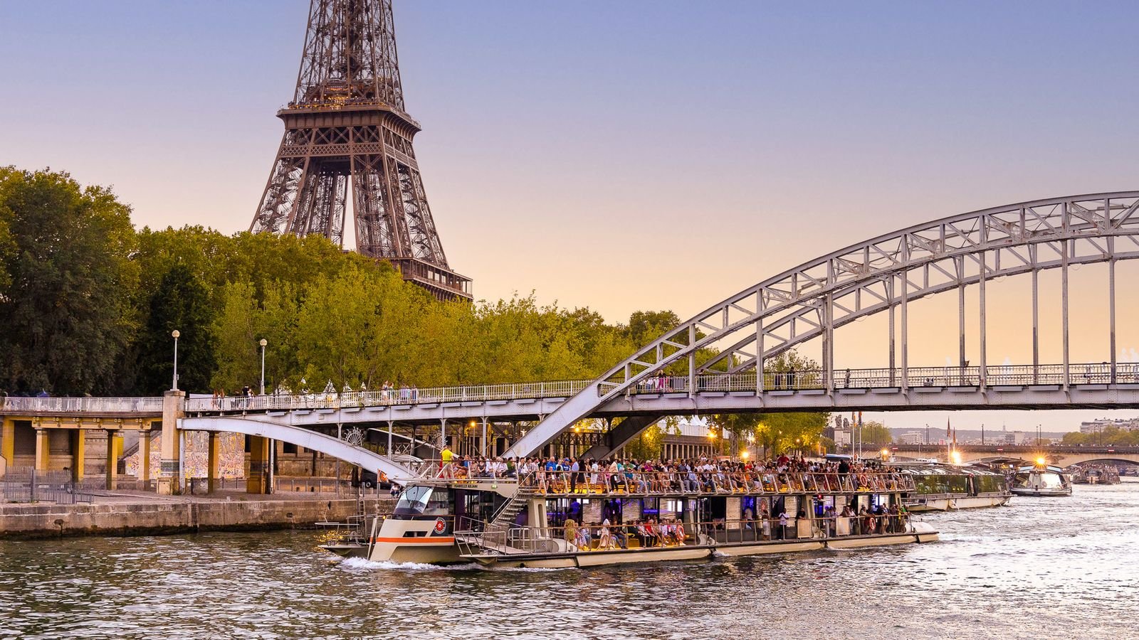 Bateaux Parisiens boat cruising on the Seine River near the Eiffel Tower in Paris