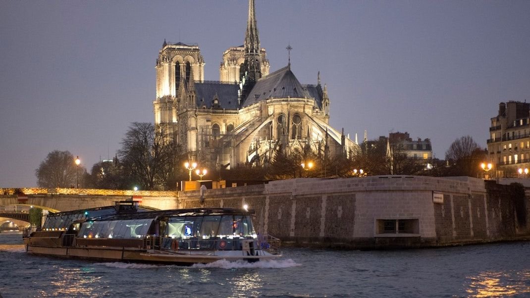 Bateaux Parisiens glass boat sailing along the Seine River in Paris