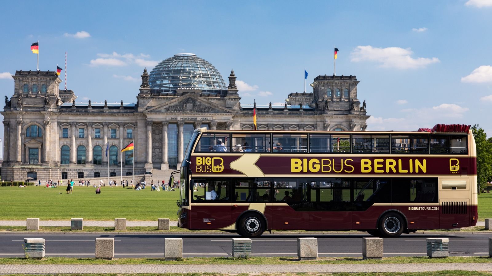 Sightseeing tour bus passing Brandenburg Gate in Berlin