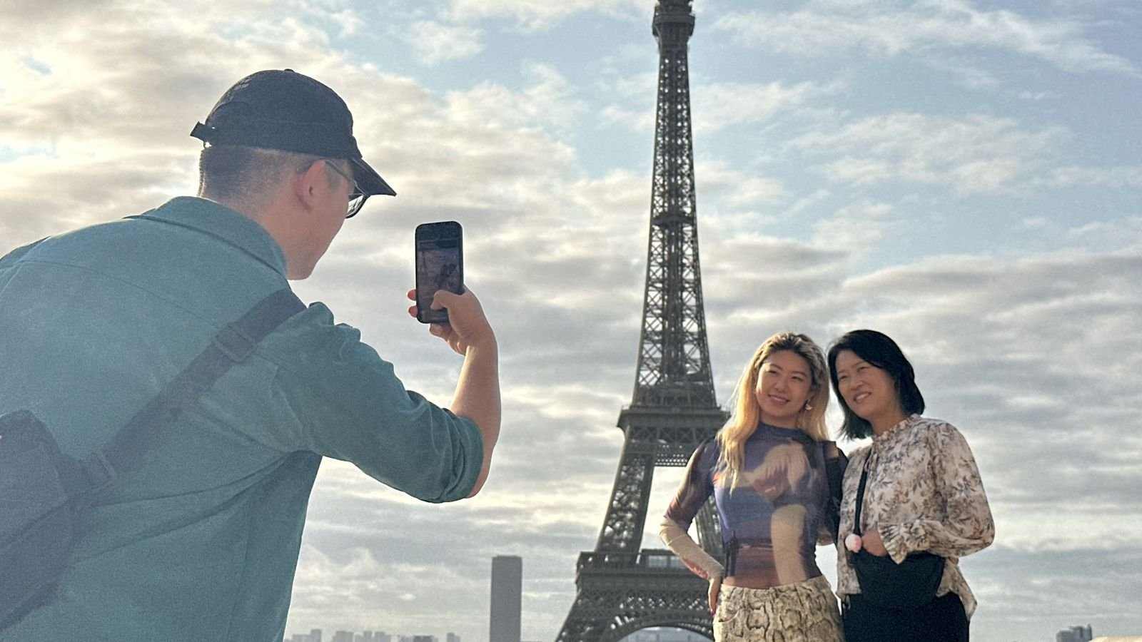 Tour guide walking with visitors towards the Eiffel Tower