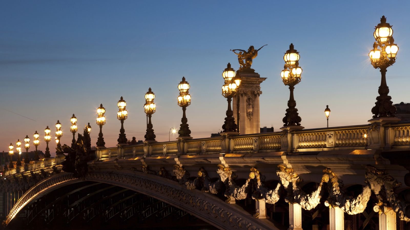 Eiffel Tower illuminated against the Paris night sky
