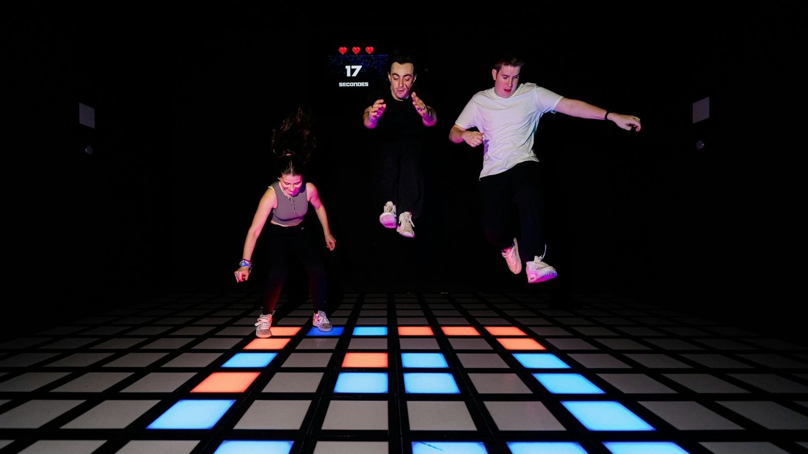 Participants playing an interactive challenge room at Activate Games Paris