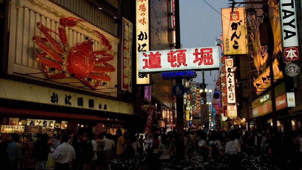Osaka Night Food Tour guide walking through Dotonburi alleys