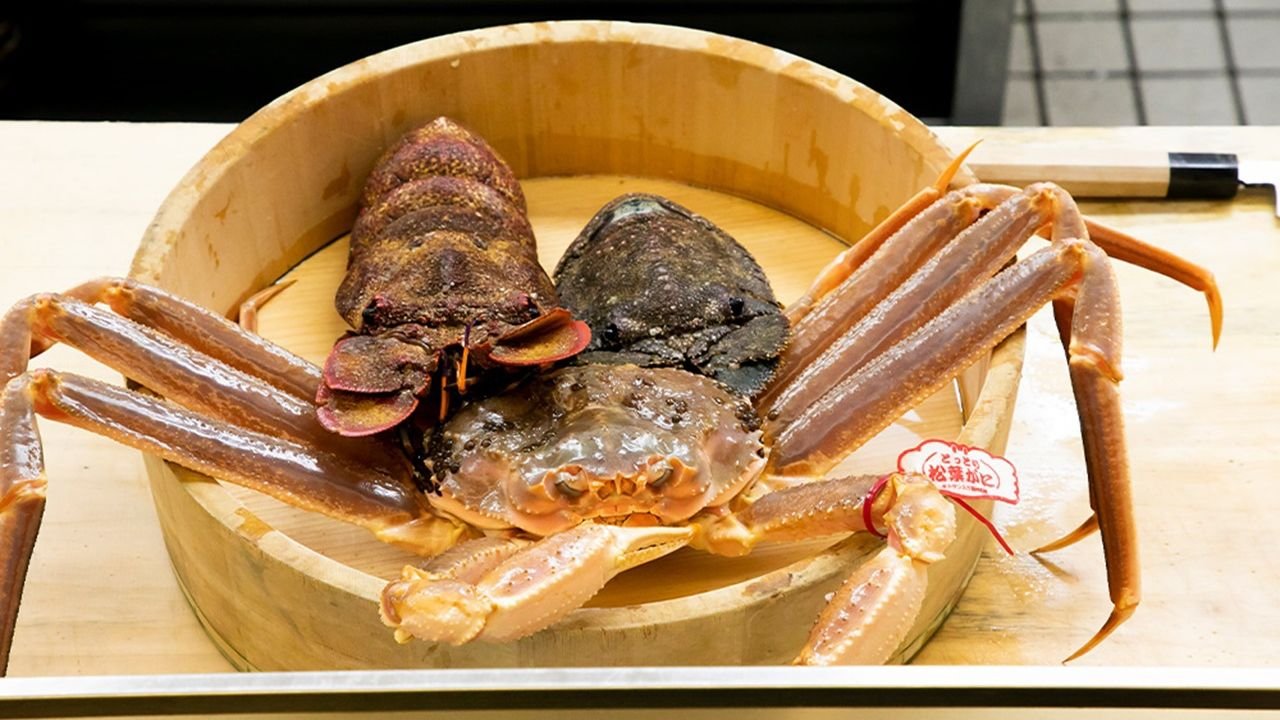 Chef preparing seasonal kaiseki dishes at the dining counter