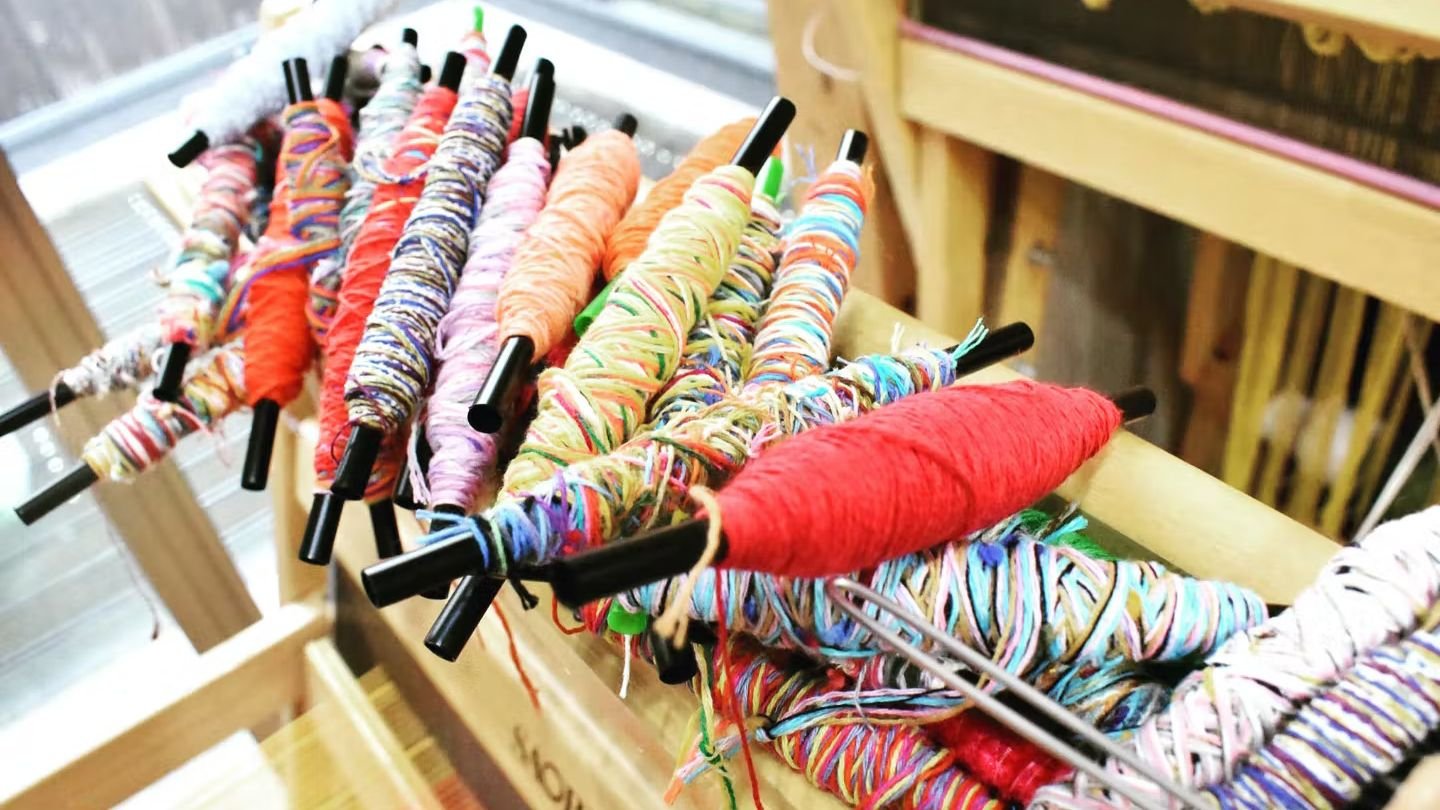 Hand weaving on a loom at SAORI Toyosaki Nagaya