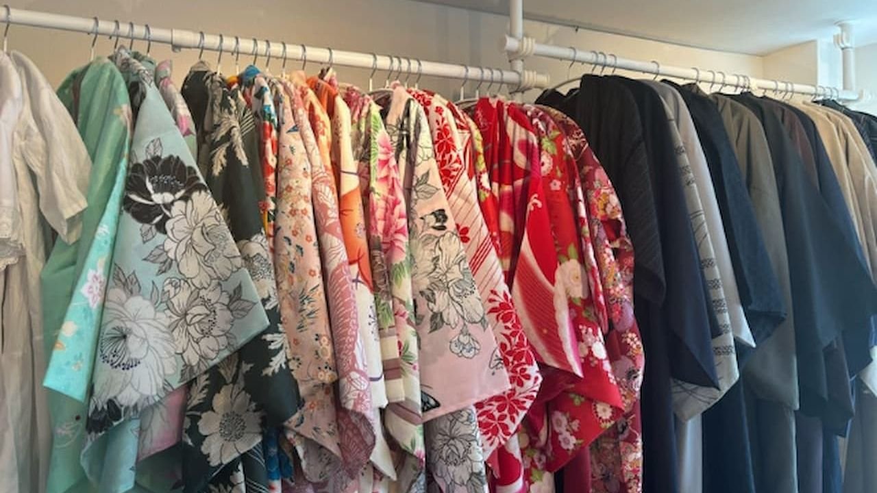 Staff providing dressing assistance with Japanese kimono and obi