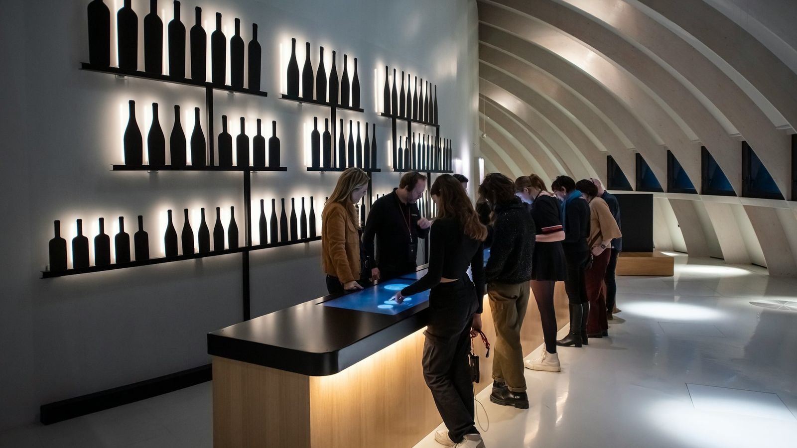 Visitor holding a digital audio guide inside the exhibition