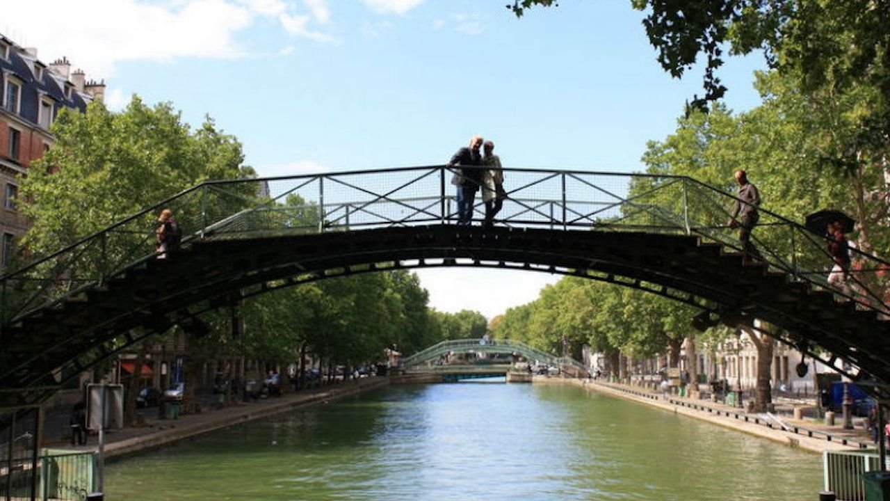 Canal Saint-Martin tree-lined embankment with locals