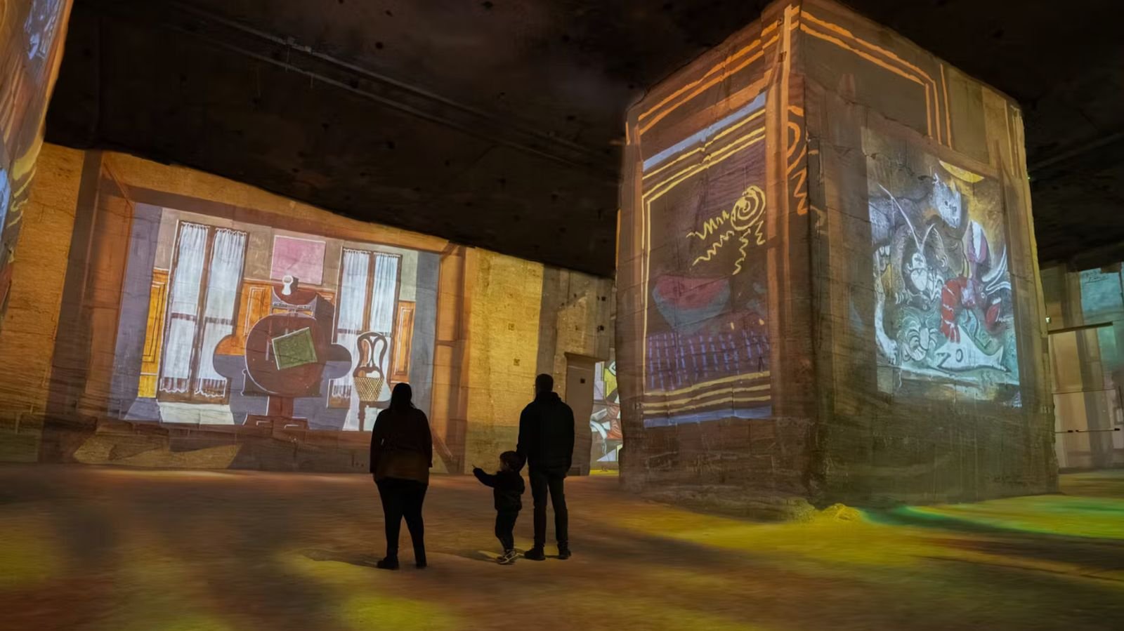 Digital art projections on towering stone quarry walls