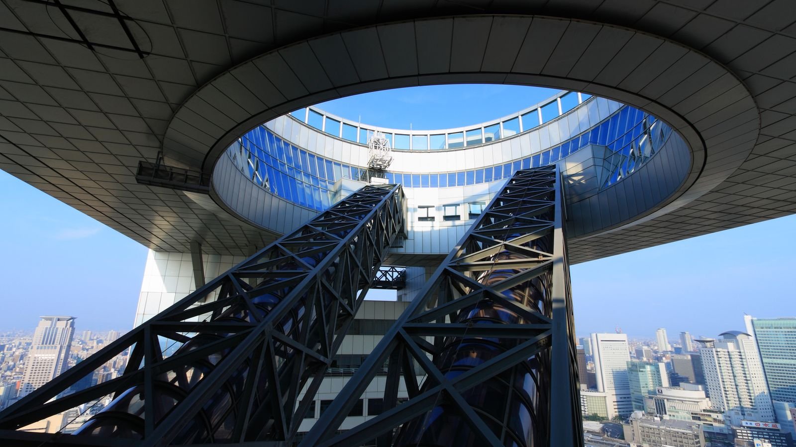 Glass-enclosed escalators ascending through the circular crown