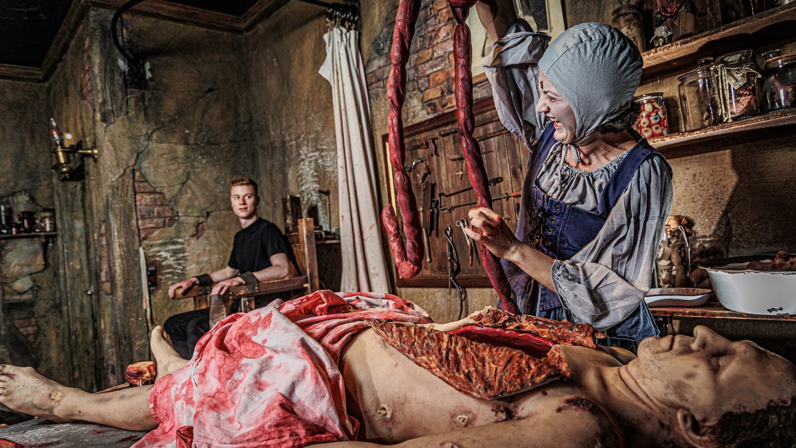 Live actors staging historical London scenes inside The London Dungeon
