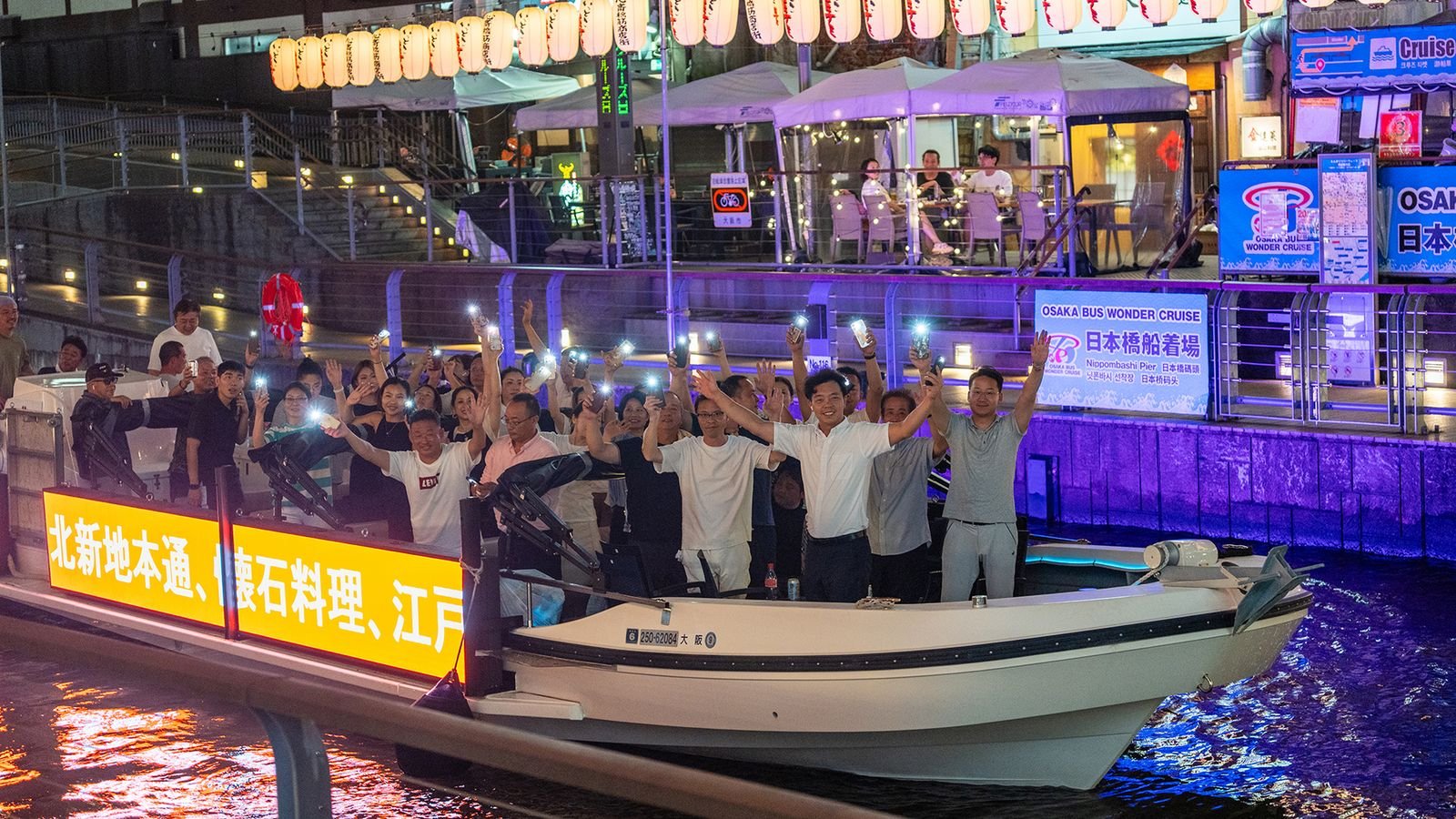 Dotonbori River in Osaka with neon signs reflected on the water during evening