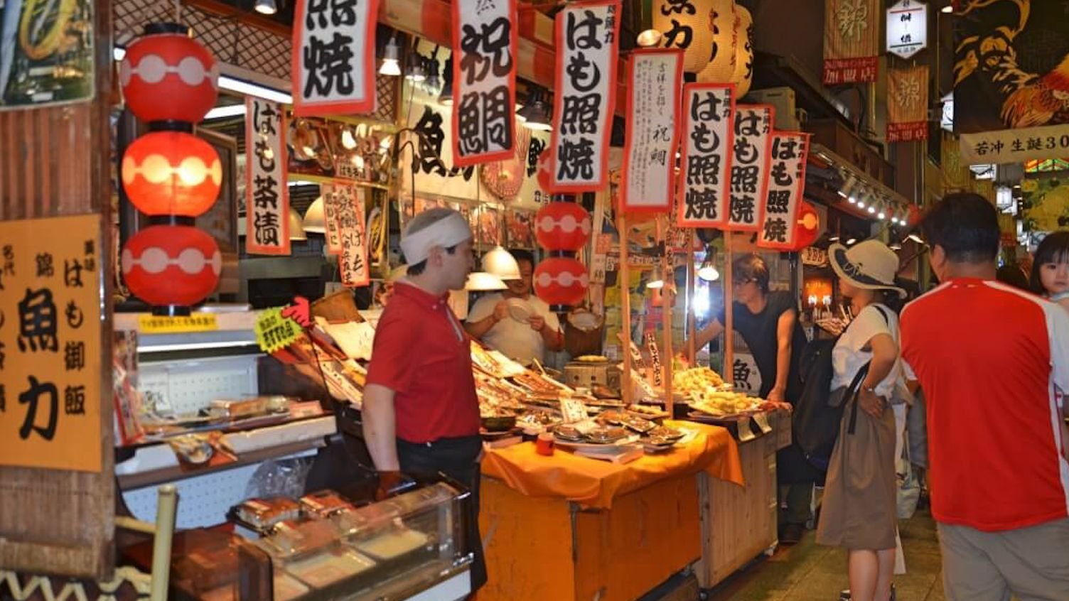 Family-owned food stalls lining Nishiki Market in Kyoto