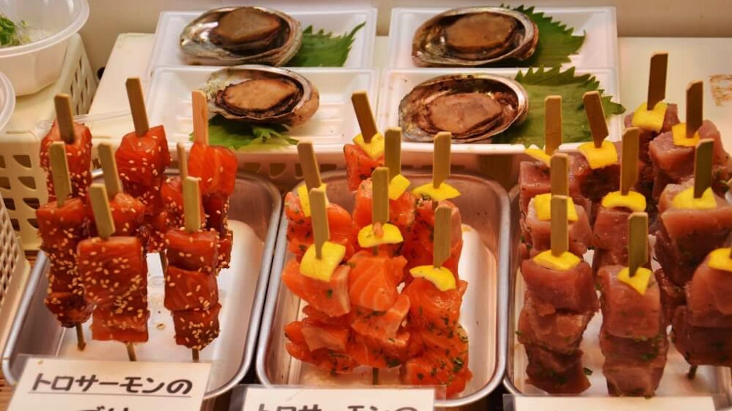 Fresh seasonal seafood and dishes on display at Nishiki Market