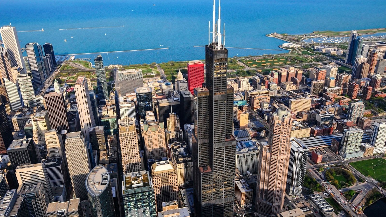 Visitor standing on The Ledge glass balcony extending from Willis Tower