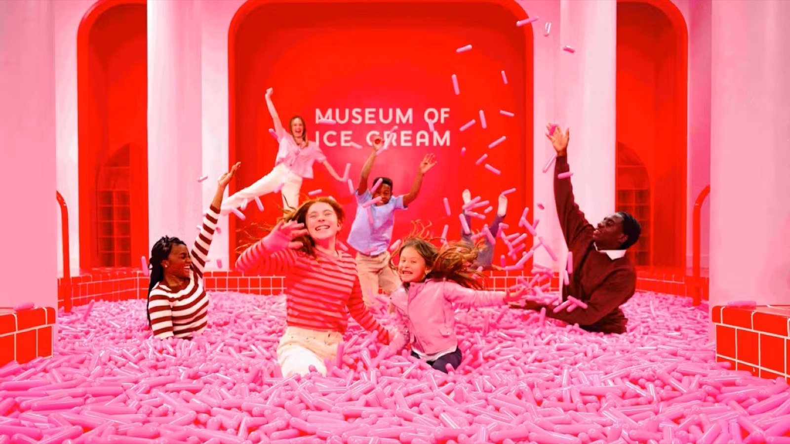 Visitors swimming in the colourful Sprinkle Pool at Museum of Ice Cream Boston