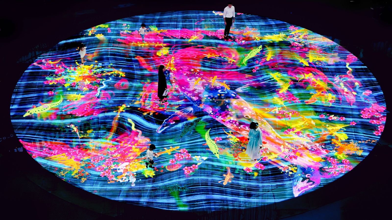 Visitors interacting with light art