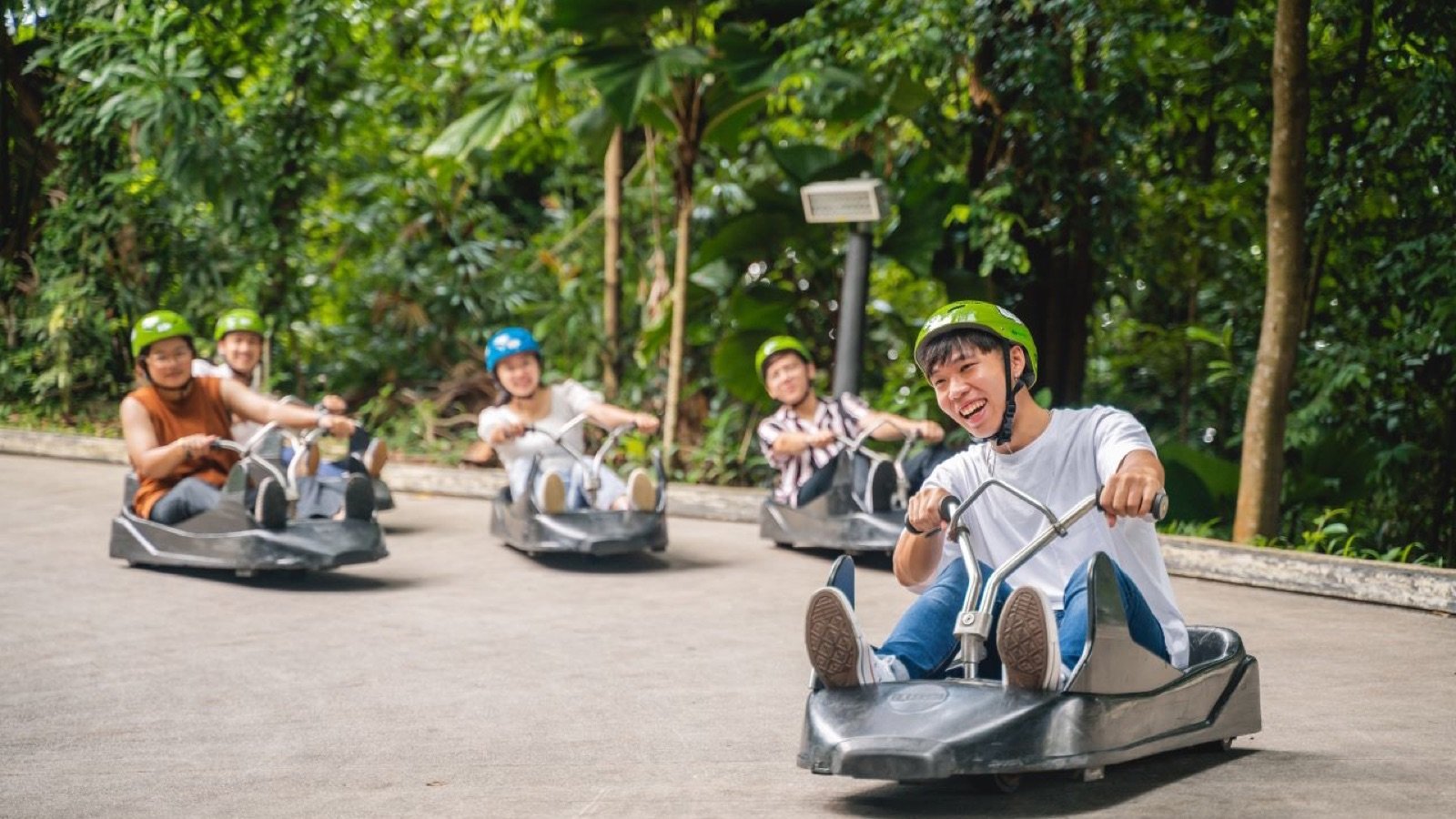 Rider steering a three-wheeled cart at Skyline Luge Kuala Lumpur