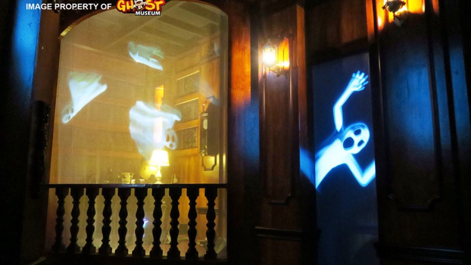 Visitors posing in complimentary scary costumes with themed props