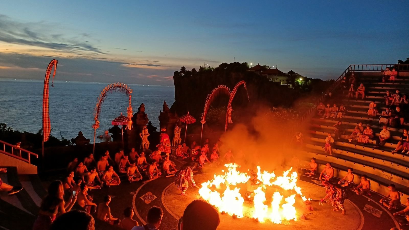 Fire dance ritual with performer stepping through glowing embers