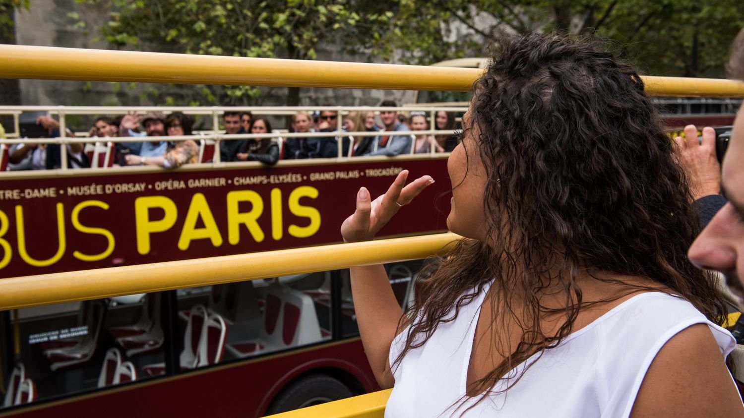 Big Bus Paris passing Notre-Dame Cathedral