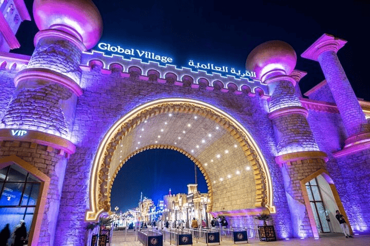 Global Village Dubai at night with cultural shows, food stalls, and carnival rides, a popular Dubai night attraction.
